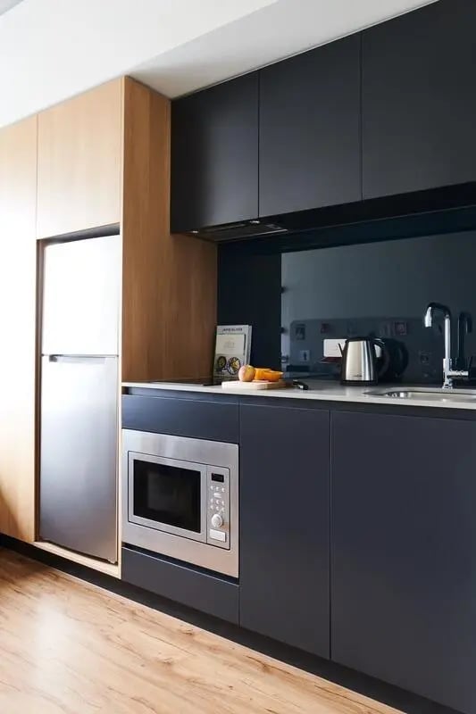Modern kitchen with stainless steel fridge and microwave Kitchen at Scape Uni Square in Melbourne Student Accommodation