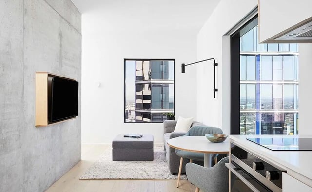 Modern living space with sofa dining table and kitchen living room at Scape Franklin in Melbourne Student Accommodation