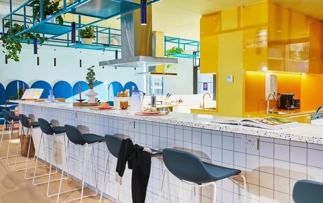 Bar stools and counter with kitchen appliances kitchen at Scape Franklin in Melbourne Student Accommodation