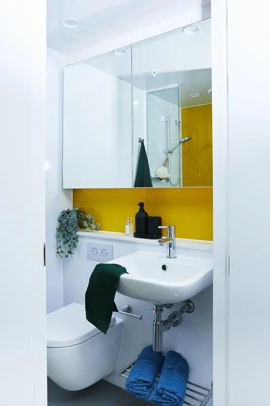 Toilet sink mirror shower yellow bathroom at Scape Franklin in Melbourne Student Accommodation