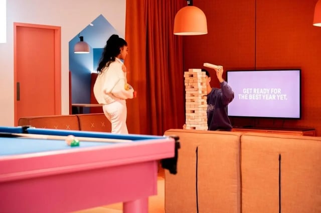 Pool table and Jenga game in living room at Scape Franklin in Melbourne Student Accommodation