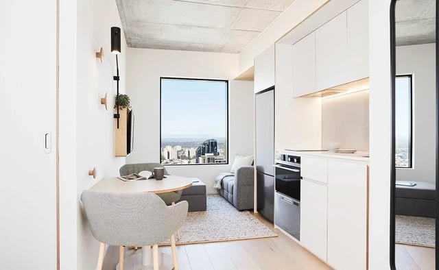 Compact living room with kitchen dining living area at Scape Franklin in Melbourne Student Accommodation