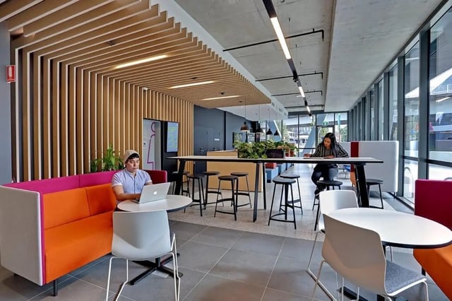 Students using laptops in a modern lounge area at Scape Darling House in Sydney Student Accommodation