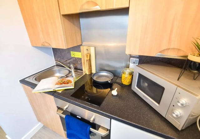 Sink induction hob microwave cooking area kitchen at iQ Steel in Sheffield Student Accommodation