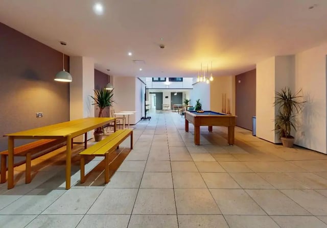 Pool table long yellow table benches communal area at iQ Steel in Sheffield Student Accommodation