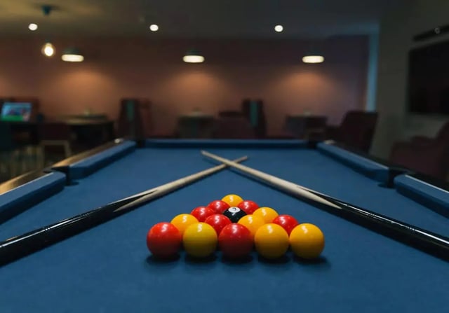 Billiard balls racked on table with cues Playing area at iQ Brocco in Sheffield Student Accommodation