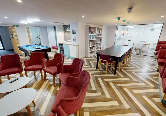 Pool table chairs tables bookshelf lounge area at iQ Brocco in Sheffield Student Accommodation