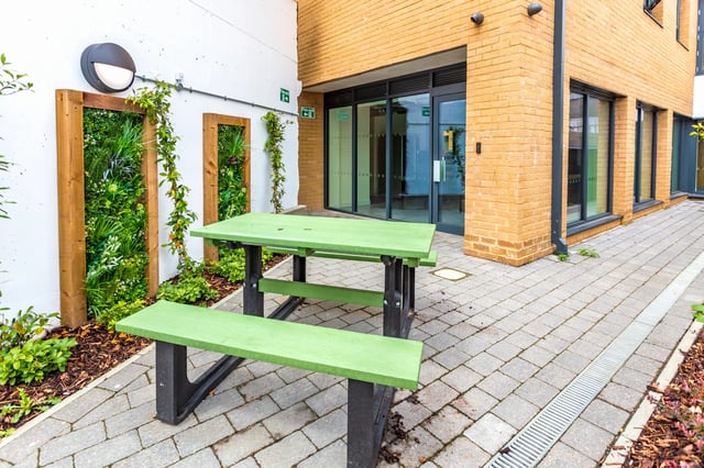 Picnic table green plants building exterior at Holden Court in Brighton Student Accommodation