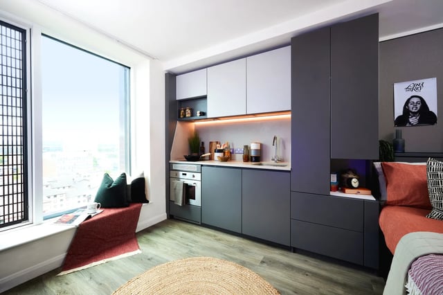 Compact kitchen with window seat and bed. Kitchen living room. at Vita Student Manchester Circle Square in Manchester Student Accommodation