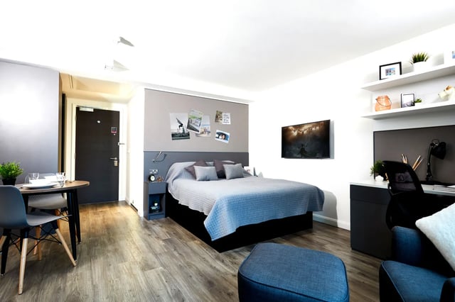 Bed with pillows and a desk study area at Vita Student Manchester Circle Square in Manchester Student Accommodation