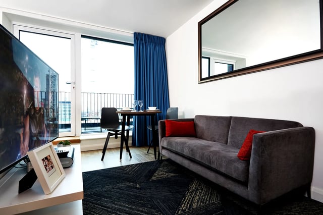 Sofa dining table TV with picture living room at Vita Student Manchester Circle Square in Manchester Student Accommodation