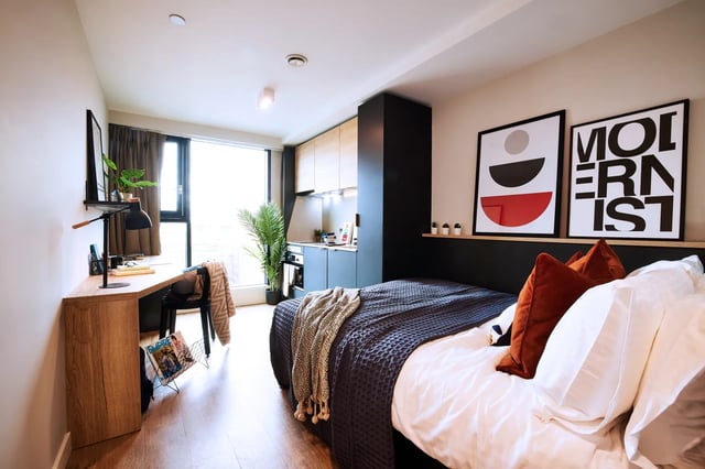 Bed desk kitchen area modern studio apartment at Vita Student Manchester Circle Square in Manchester Student Accommodation