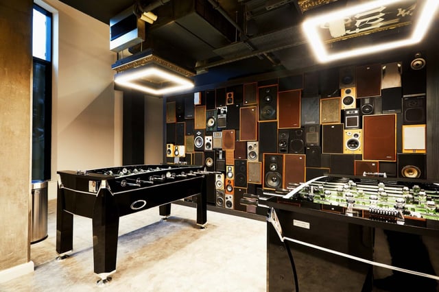 Foosball tables with vintage speakers wall entertainment room at Vita Student Manchester Circle Square in Manchester Student Accommodation