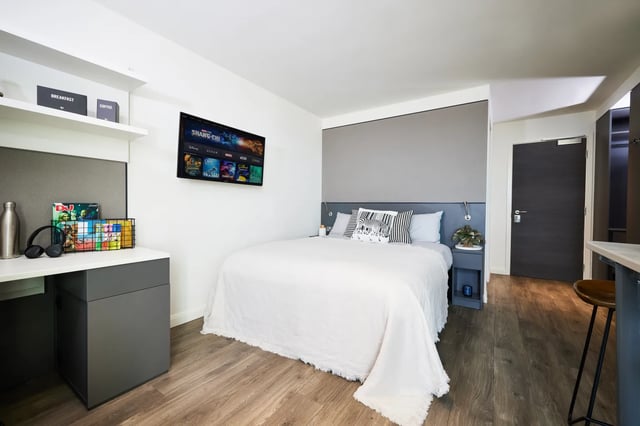 Bed desk TV shelves and door bedroom at Vita Student Newcastle Strawberry Place in Newcastle Upon Tyne Student Accommodation