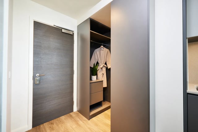 Door wardrobe robe plant and drawers closet at Vita Student Newcastle Strawberry Place in Newcastle Upon Tyne Student Accommodation