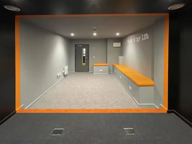 Orange cushioned benches grey walls open room communal area at The Bridge Guildford in Guildford Student Accommodation