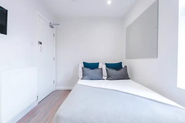 Bed with pillows radiator door whiteboard Bedroom at 90 Ashford Street in Stoke-On-Trent Student Accommodation