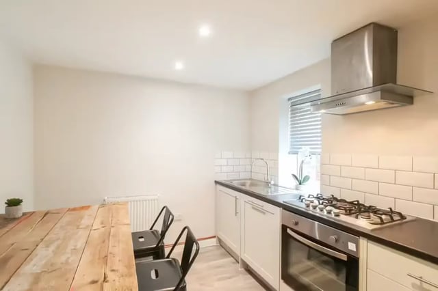 Wooden table two chairs oven hob sink kitchen at 90 Ashford Street in Stoke-On-Trent Student Accommodation