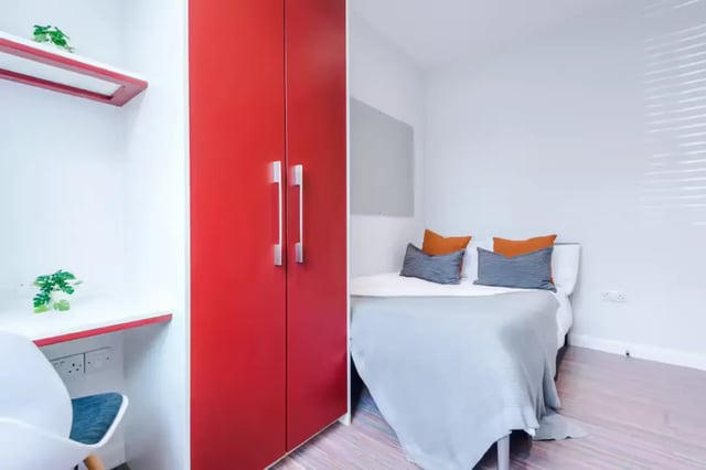 Red wardrobe desk chair bed with pillows bedroom at 90 Ashford Street in Stoke-On-Trent Student Accommodation