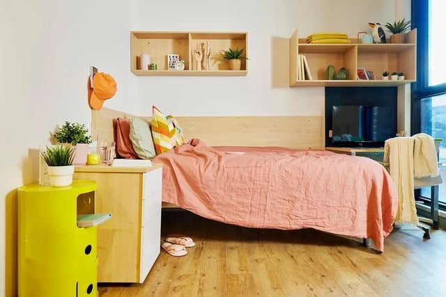 Bed with pink duvet pillows bedside table bedroom at Scape Cleveland in Sydney Student Accommodation
