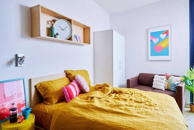Yellow bed framed picture and sofa bedroom at Scape Cleveland in Sydney Student Accommodation