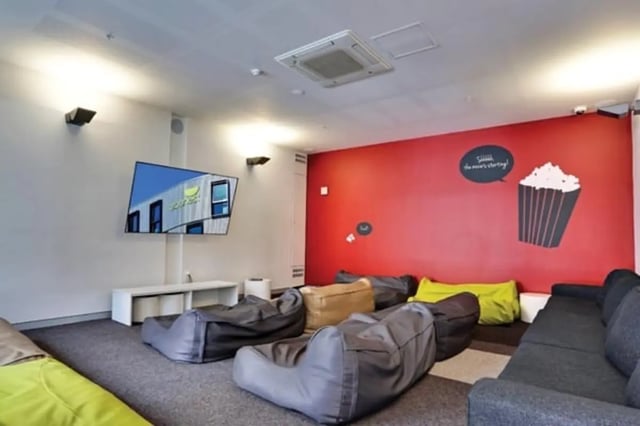 Bean bags couch TV and red wall common area at Scape Cleveland in Sydney Student Accommodation