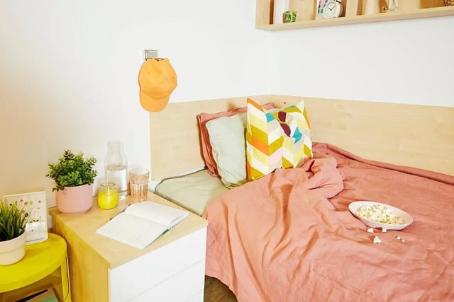 Bed with pink covers popcorn and pillows bedroom at Scape Cleveland in Sydney Student Accommodation