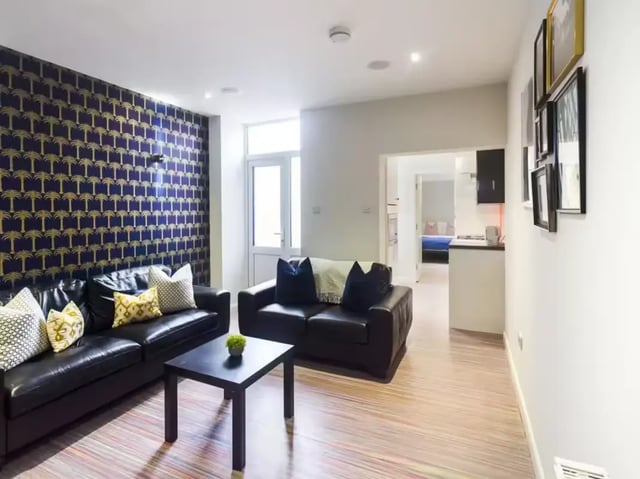 Two black sofas and coffee table living room at 19 Carlton Road in Stoke-On-Trent Student Accommodation
