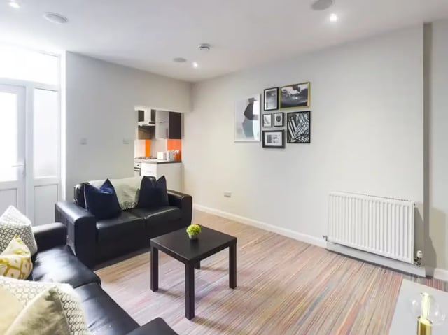 Black sofa with pillows and coffee table living room at 19 Carlton Road in Stoke-On-Trent Student Accommodation