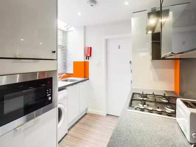 Microwave washer sink stove toaster kitchen interior at 19 Carlton Road in Stoke-On-Trent Student Accommodation