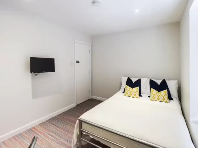 Bed with pillows TV on wall bedroom at 19 Carlton Road in Stoke-On-Trent Student Accommodation