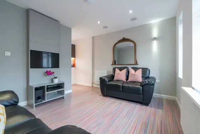 Black sofa patterned floor TV unit living room at 16 Queen Anne Street in Stoke-On-Trent Student Accommodation