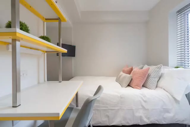 Desk shelves bed and pillows bedroom at 16 Queen Anne Street in Stoke-On-Trent Student Accommodation