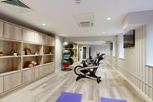 Spin bikes storage shelves and yoga mats gym area at Briggate Studios in Leeds Student Accommodation