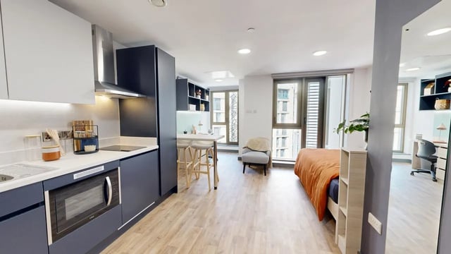 Modern studio apartment with kitchen and bed. at Tribeka in Leeds Student Accommodation