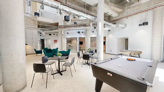 Pool table foosball table green sofas study area communal area at Tribeka in Leeds Student Accommodation