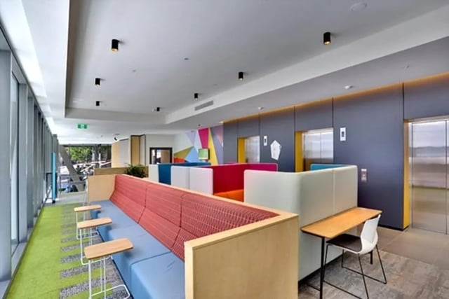 Colorful seating area with desks and elevators living area at Scape Darling Square in Sydney Student Accommodation