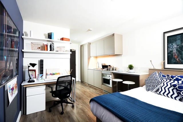 Desk kitchen bed with blue blanket Bedroom Studio at Vita Student Newcastle Westgate in Newcastle Upon Tyne Student Accommodation