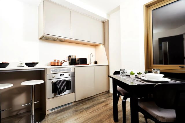 Modern student kitchen with dining table and oven kitchen at Vita Student Newcastle Westgate in Newcastle Upon Tyne Student Accommodation