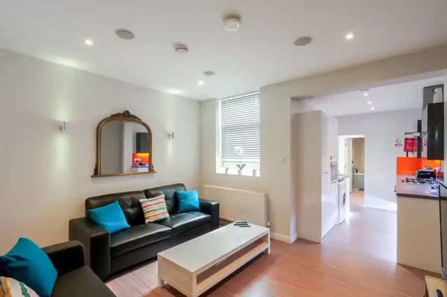 Black sofa white table mirror kitchen living room at 64 Seaford Street in Stoke-On-Trent Student Accommodation
