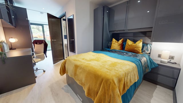 Bed desk chair and wardrobe bedroom at The Residence in Coventry Student Accommodation