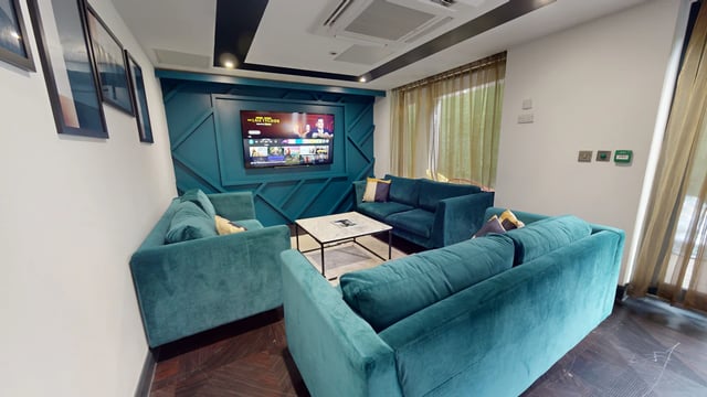 Sofa and television in a communal living room. at The Residence in Coventry Student Accommodation