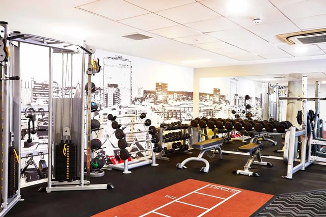 Gym equipment dumbbells barbells and weight machines gym at Vita Student Manchester First Street in Manchester Student Accommodation