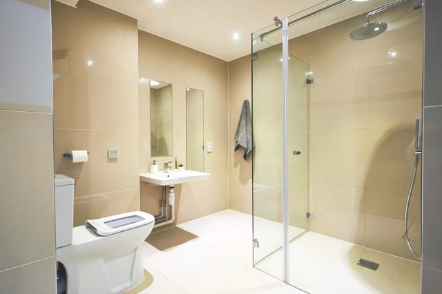 Toilet sink shower with towel bathroom at Vita Student Manchester First Street in Manchester Student Accommodation