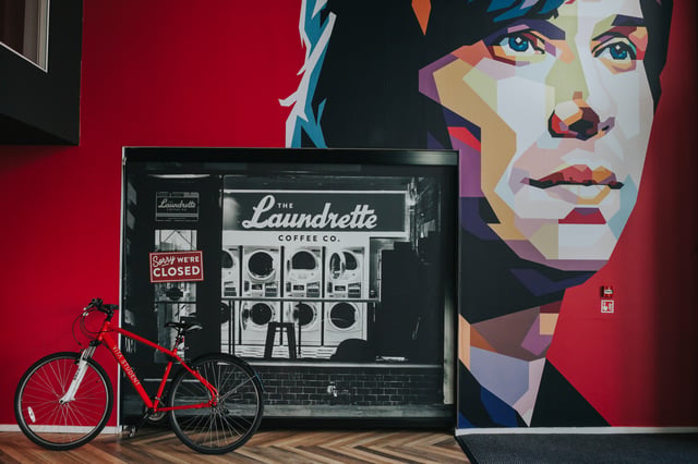 Red bicycle laundrette photo mural exterior at Vita Student Manchester First Street in Manchester Student Accommodation