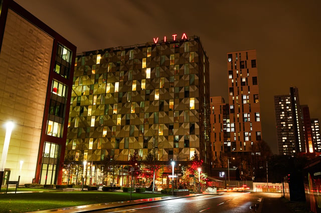 Modern buildings lit at night exterior at Vita Student Manchester First Street in Manchester Student Accommodation