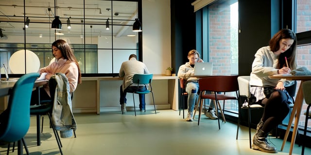 Students studying at desks with laptops and notebooks Study area at Canvas Coventry Arundel House in Coventry Student Accommodation