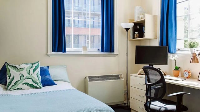 Bed desk chair computer and window bedroom at Queen's Hospital Close in Birmingham Student Accommodation