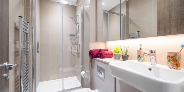 Shower sink towels plants and toilet bathroom at Canvas Coventry City Club in Coventry Student Accommodation