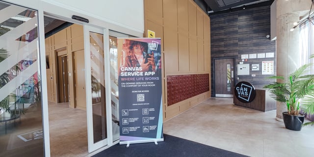 Service app banner mailboxes and reception desk exterior at Canvas Coventry City Club in Coventry Student Accommodation